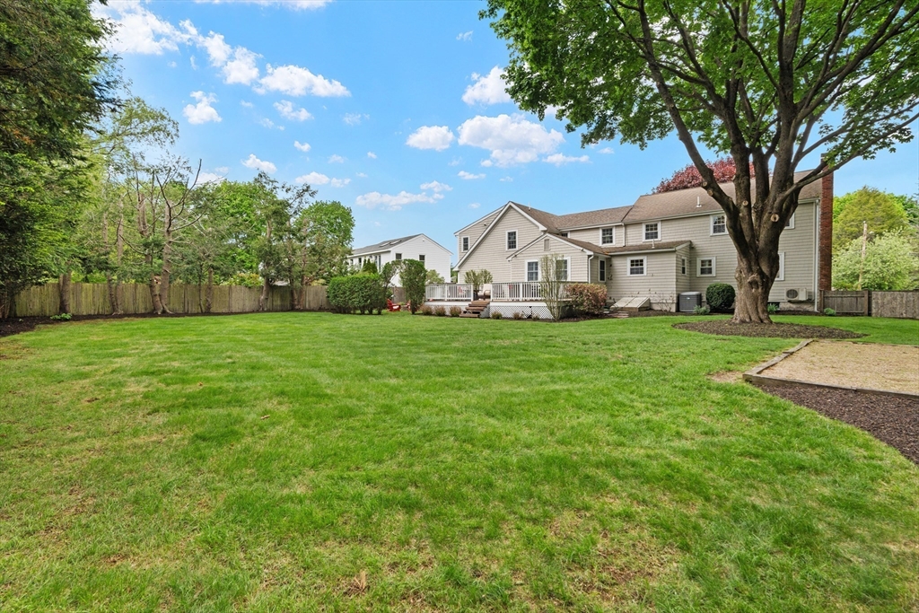26 Cushing Road Westwood, MA 02090 - Photo 3 of 42 a view of a white house that has a tree in front of a house