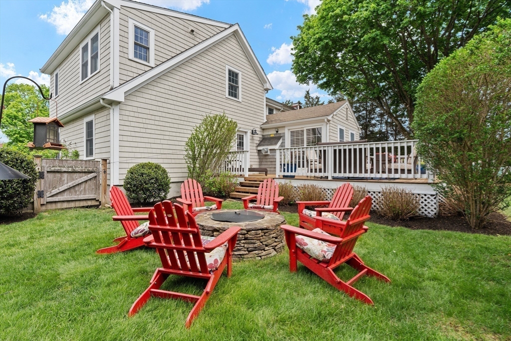 26 Cushing Road Westwood, MA 02090 - Photo 38 of 42 a backyard of a house with table and chairs
