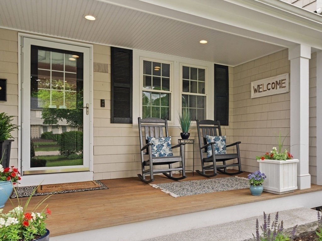 26 Cushing Road Westwood, MA 02090 - Photo 4 of 42 a wooden bench sitting in front of a building