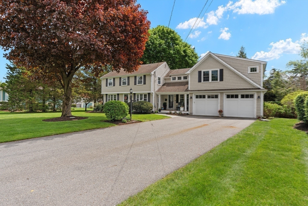 26 Cushing Road Westwood, MA 02090 - Photo 41 of 42 a front view of a house with a yard and garage