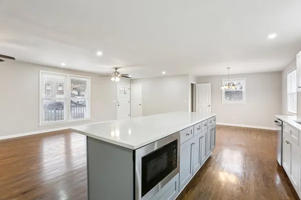 a view of a kitchen island wooden floor and windows