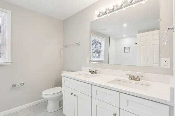 a bathroom with a sink toilet and a mirror