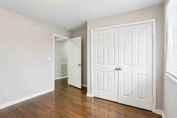 an empty room with wooden floor