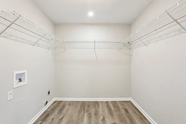 a view of a room with wooden floor