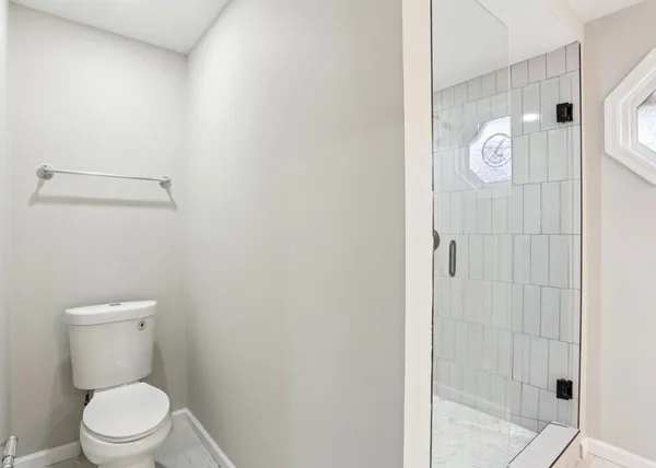 a white toilet sitting next to a bathroom sink