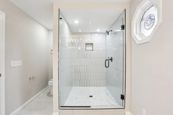 a bathroom with a glass shower door