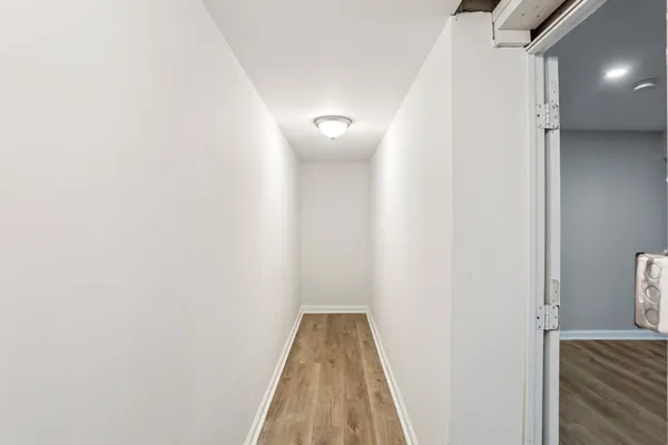 a view of a hallway with wooden floor