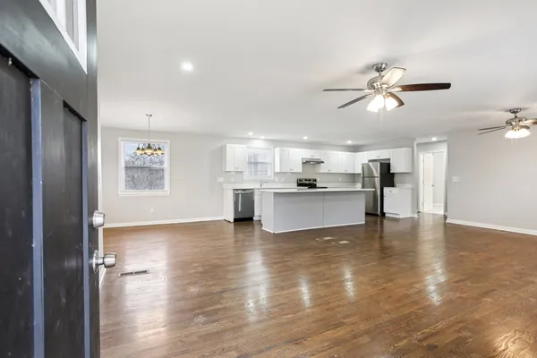 a view of kitchen with livingroom and wooden floor