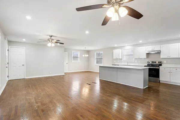 a view of a kitchen with a sink cabinets and wooden floor