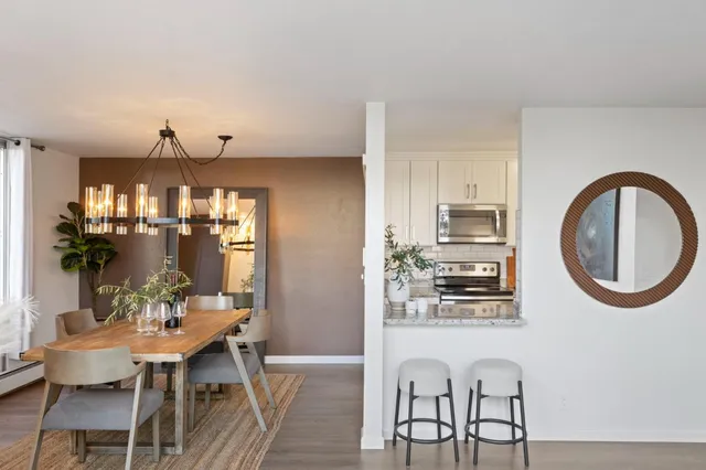 a view of a dining room with furniture and chandelier