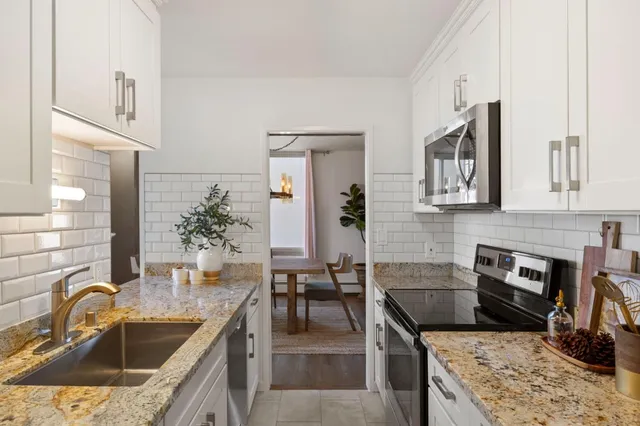 a kitchen with a stove and a sink