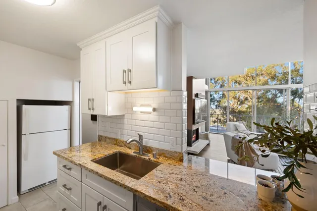 a kitchen that has a sink and a refrigerator
