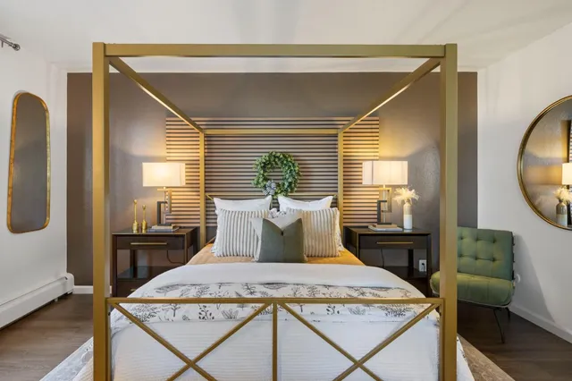 a bedroom with a bed and wooden floor