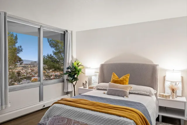 a bedroom with a bed and a large window