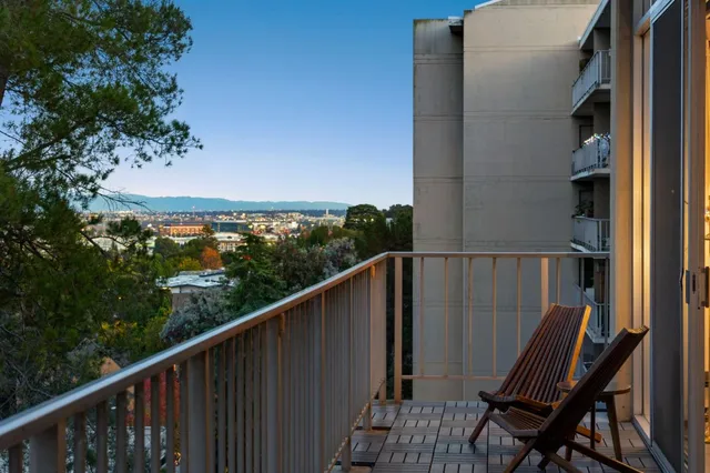 a view of a balcony with chair and wooden floor