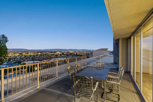 a view of a balcony with table and chairs