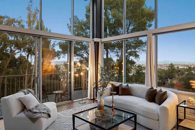 a balcony with furniture and a potted plant