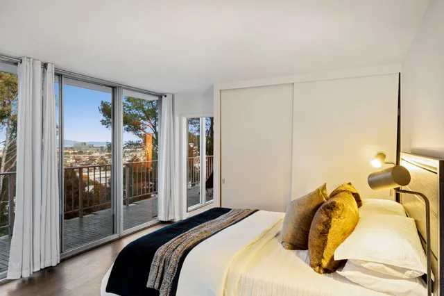 a bedroom with a bed and glass door