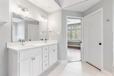 a bathroom with a double vanity sink and a mirror