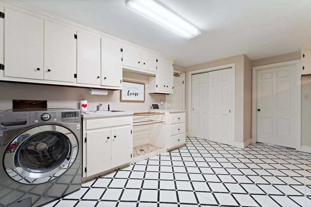 12 Winthrop Road Wayland, MA 01778 - Photo 20 of 22 a room with a washing machine and cabinets