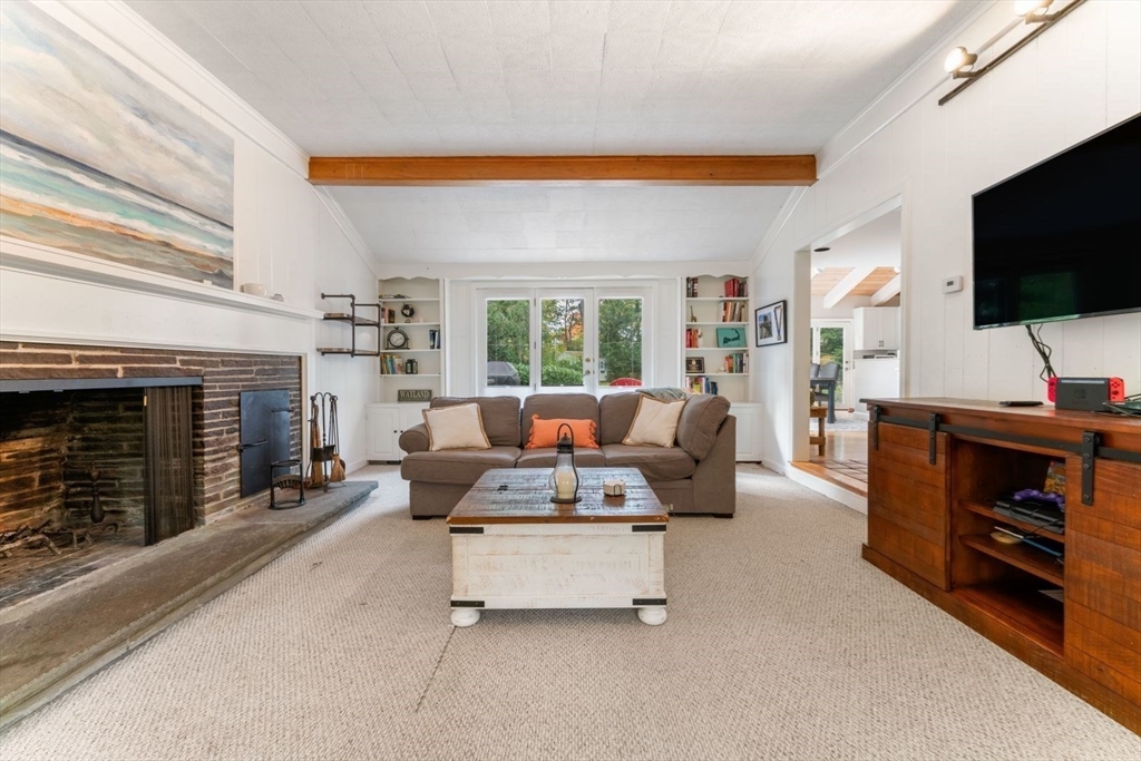 12 Winthrop Road Wayland, MA 01778 - Photo 5 of 22 a living room with furniture a flat screen tv and a fireplace