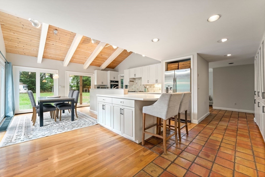 12 Winthrop Road Wayland, MA 01778 - Photo 7 of 22 a kitchen with a sink dining table and chairs