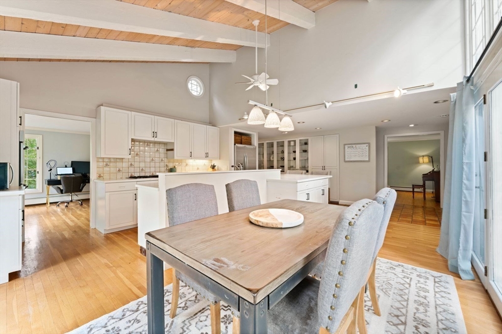 12 Winthrop Road Wayland, MA 01778 - Photo 9 of 22 a large kitchen with kitchen island a dining table and chairs