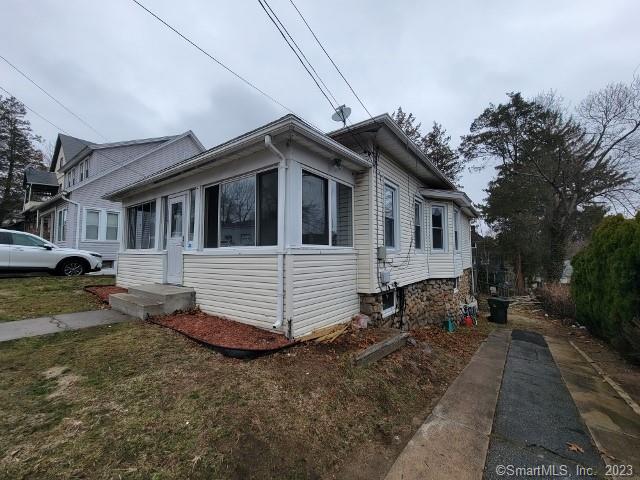 249 Vauxhall Street New London, CT 06320 - Photo 1 of 1 a view of a white house with a yard and lawn chairs