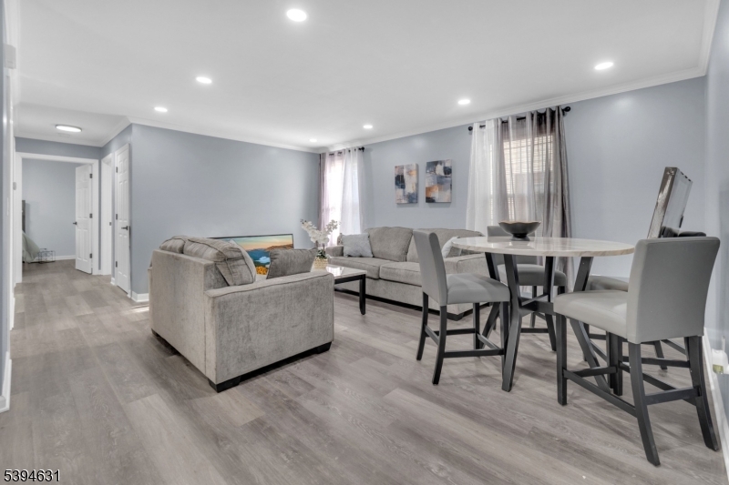 237 Rose Street, Unit 1 Newark, NJ 07108 - Photo 2 of 10 a living room with furniture and a wooden floor