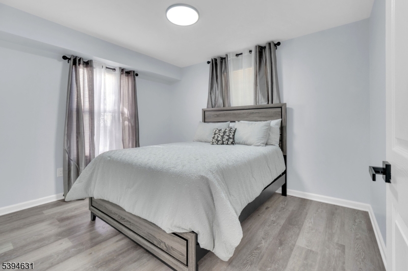 237 Rose Street, Unit 1 Newark, NJ 07108 - Photo 5 of 10 a bedroom with a bed and a window