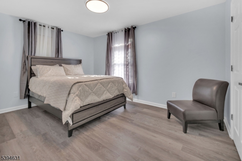 237 Rose Street, Unit 1 Newark, NJ 07108 - Photo 6 of 10 a bedroom with a bed and chair