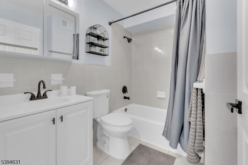 237 Rose Street, Unit 1 Newark, NJ 07108 - Photo 9 of 10 a bathroom with a sink a toilet and shower