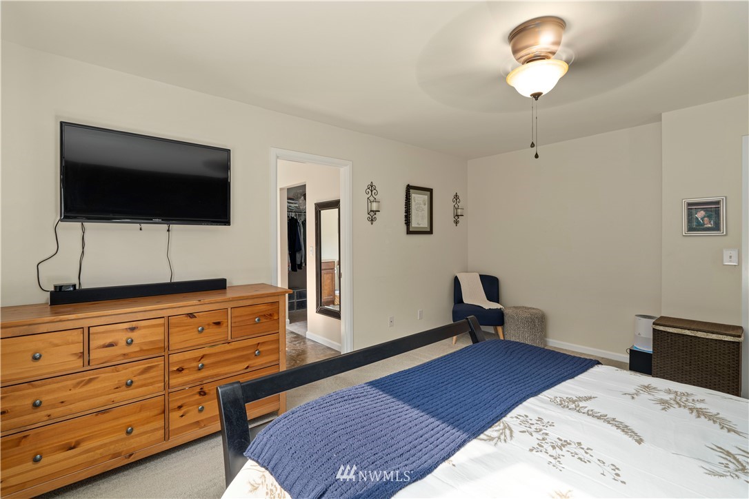 3032 183rd Place Southeast Bothell, WA 98012 - Photo 11 of 21 a bedroom with a bed and a flat screen tv