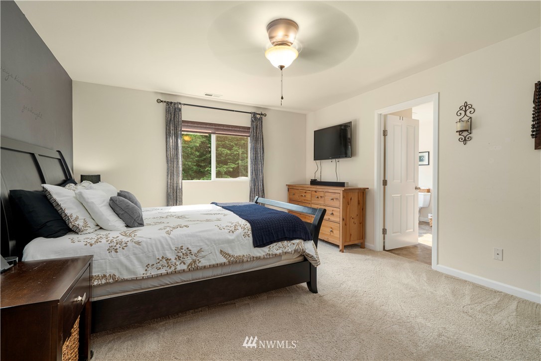 3032 183rd Place Southeast Bothell, WA 98012 - Photo 12 of 21 a bedroom with a bed and a chandelier