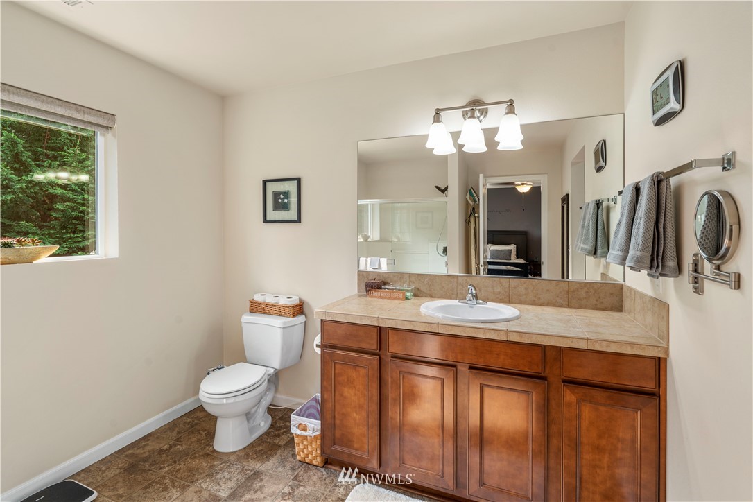3032 183rd Place Southeast Bothell, WA 98012 - Photo 13 of 21 a bathroom with a sink a toilet and a mirror