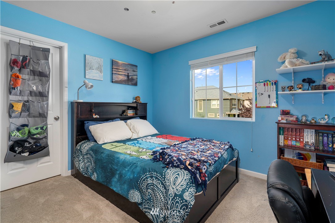3032 183rd Place Southeast Bothell, WA 98012 - Photo 14 of 21 a bedroom with a bed and dresser