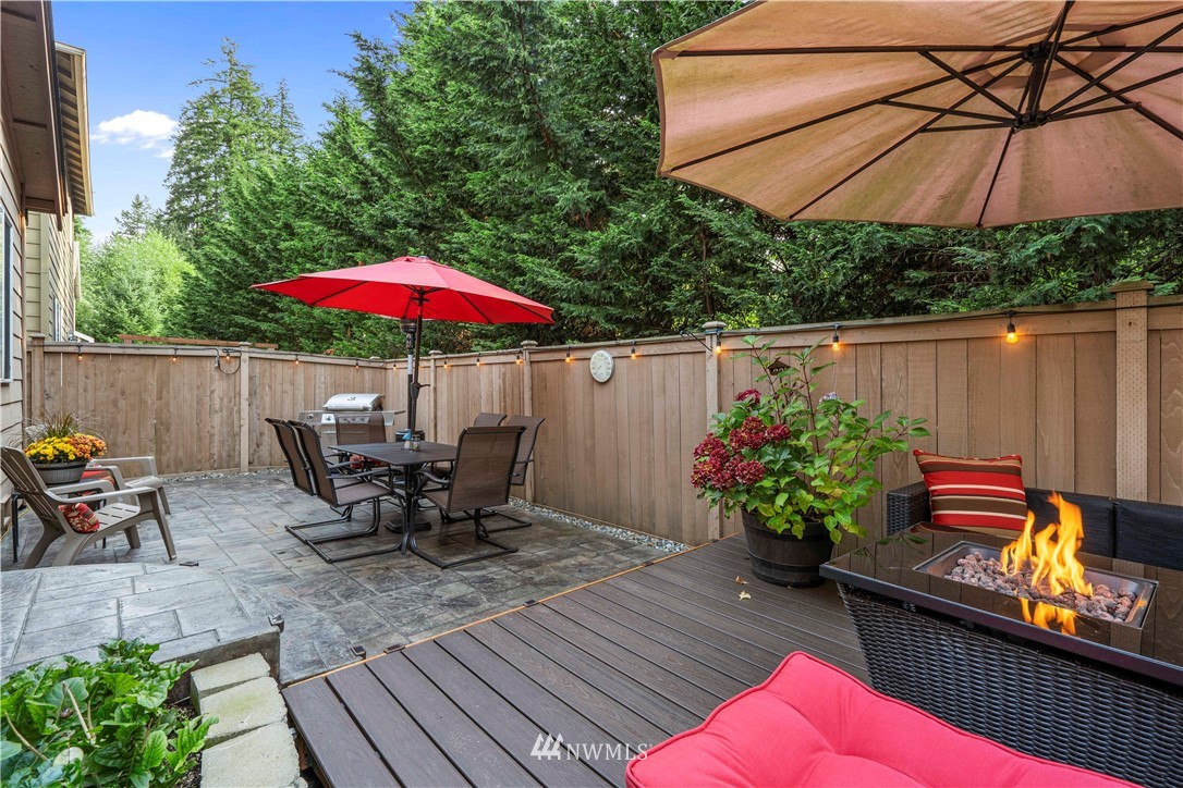 3032 183rd Place Southeast Bothell, WA 98012 - Photo 19 of 21 a patio with wooden floor a yard a table and chairs