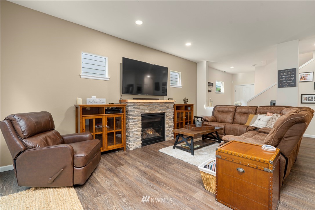 3032 183rd Place Southeast Bothell, WA 98012 - Photo 8 of 21 a living room with furniture a fireplace and a flat screen tv