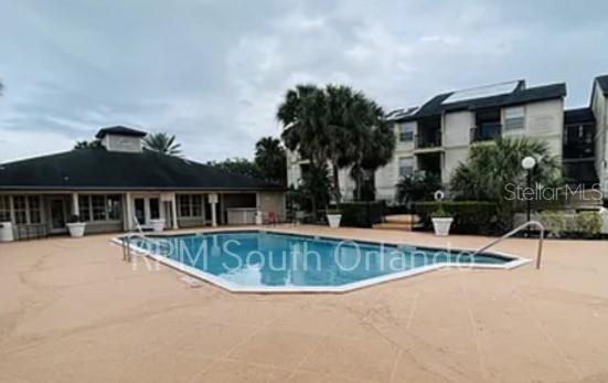 1908 Lake Atriums Circle, Unit 6 Orlando, FL 32839 - Photo 5 of 10 a view of a house with pool and chairs