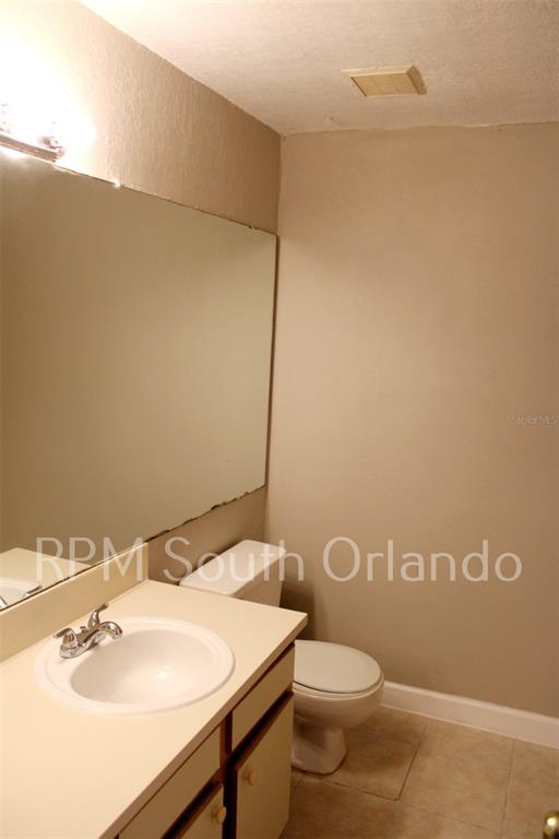 1908 Lake Atriums Circle, Unit 6 Orlando, FL 32839 - Photo 6 of 10 a bathroom with a sink a toilet and mirror
