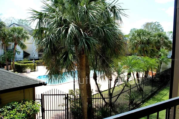 a view of entryway with palm trees