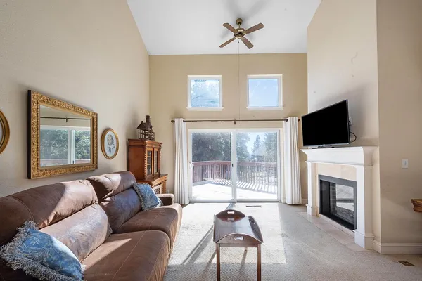 a living room with furniture a flat screen tv and a fireplace
