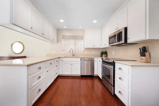 a kitchen that has a sink and a stove in it