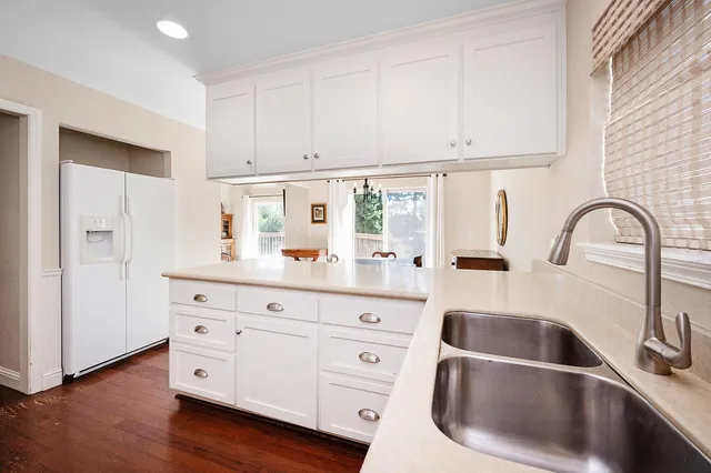 a dining room with furniture a chandelier and window