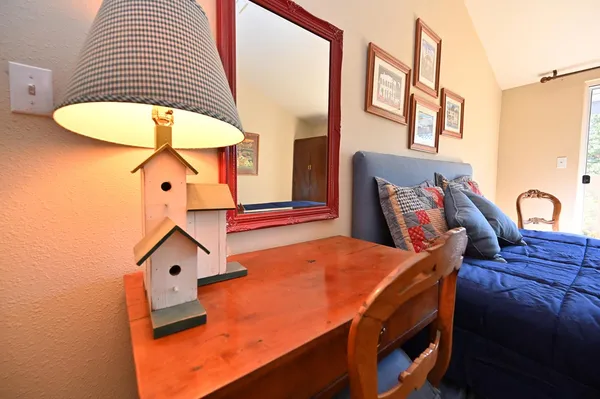 a bedroom with a bed next to a window with outer view