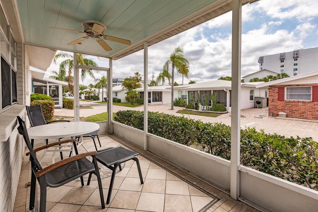 6020 Midnight Pass Road, Unit 59 Sarasota, FL 34242 - Photo 11 of 12 a view of a patio with a table chairs and glass door