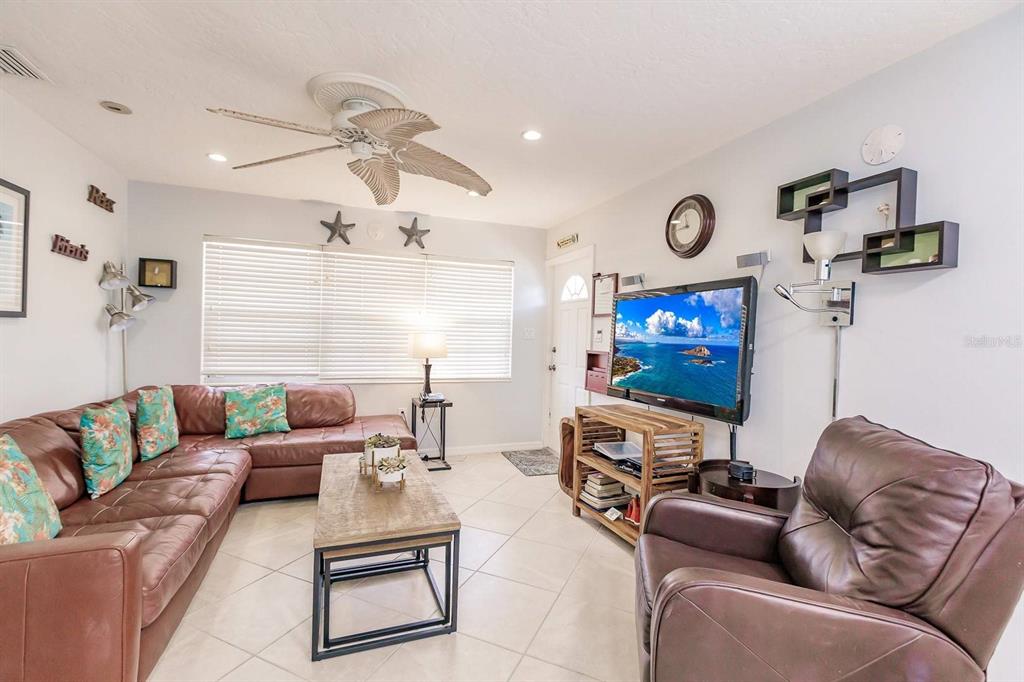 6020 Midnight Pass Road, Unit 59 Sarasota, FL 34242 - Photo 2 of 12 a living room with furniture and a flat screen tv