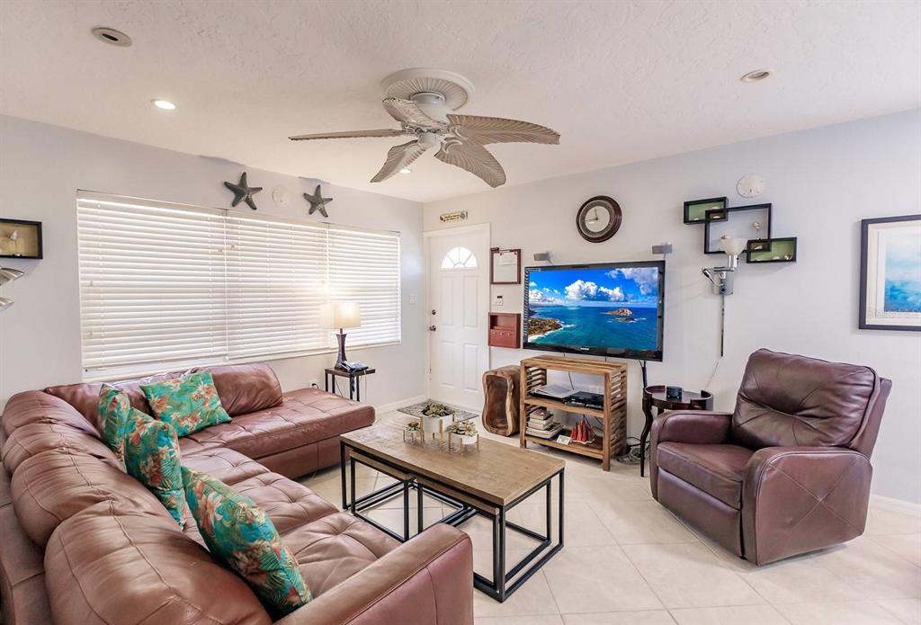 6020 Midnight Pass Road, Unit 59 Sarasota, FL 34242 - Photo 3 of 12 a living room with furniture and a flat screen tv