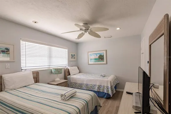 a bedroom with two beds and a window