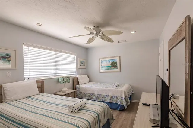 a bedroom with two beds and a window